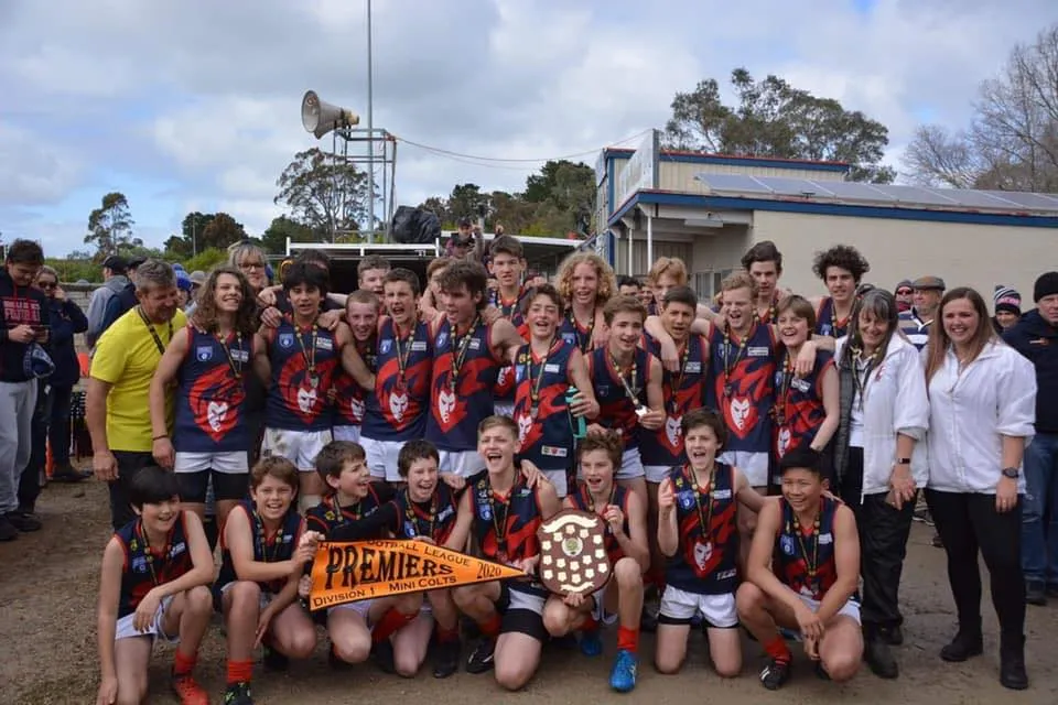 Uraidla Districts Mini Colts premiership team with their pennant and shield outside the clubrooms